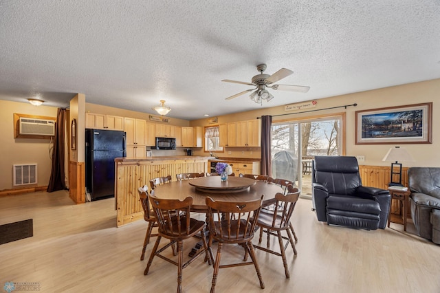 15924 Blackhawk Rd, Lake Park, MN 56554 - dining room featuring an AC wall unit, light wood-style floors, a textured ceiling, and ceiling fan