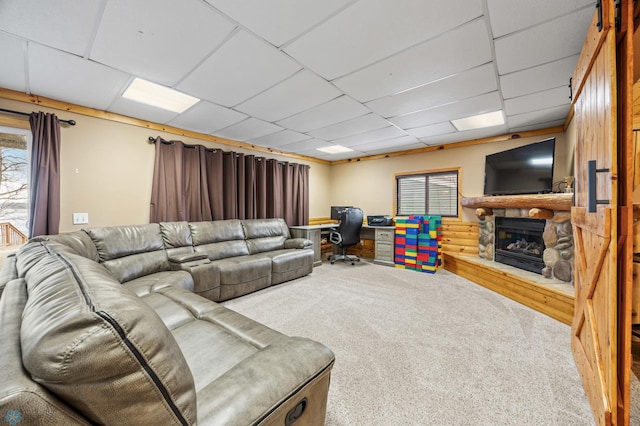 15924 Blackhawk Rd, Lake Park, MN 56554 - living area featuring carpet flooring, a desk, a stone fireplace, plenty of natural light, and a drop ceiling