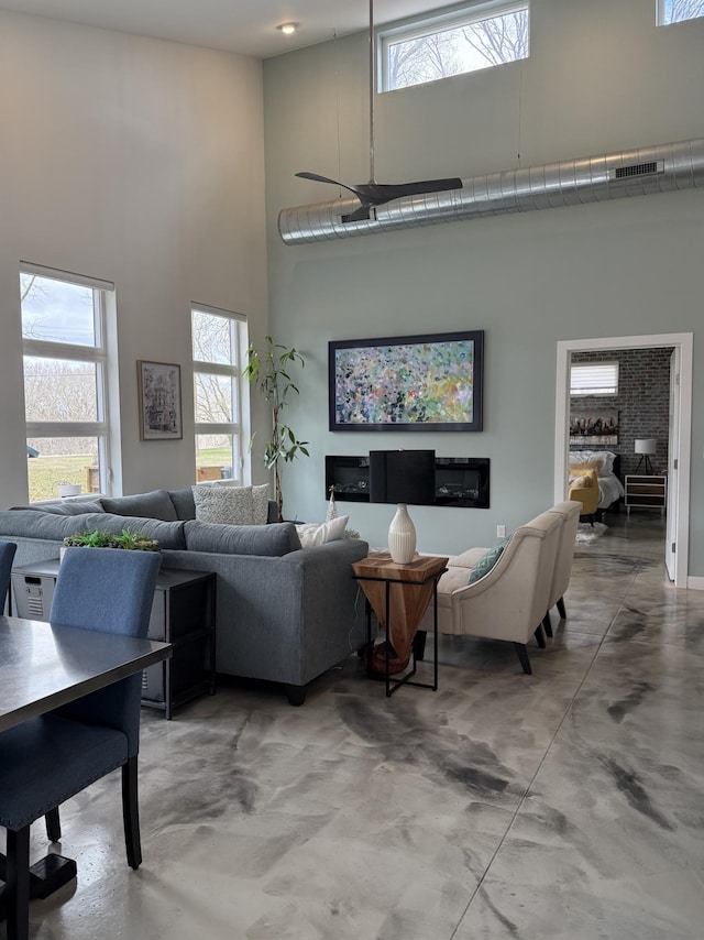 4405 17th Ave NW, Sauk Rapids, MN 56379 - living area with visible vents, a wealth of natural light, a towering ceiling, and finished concrete floors