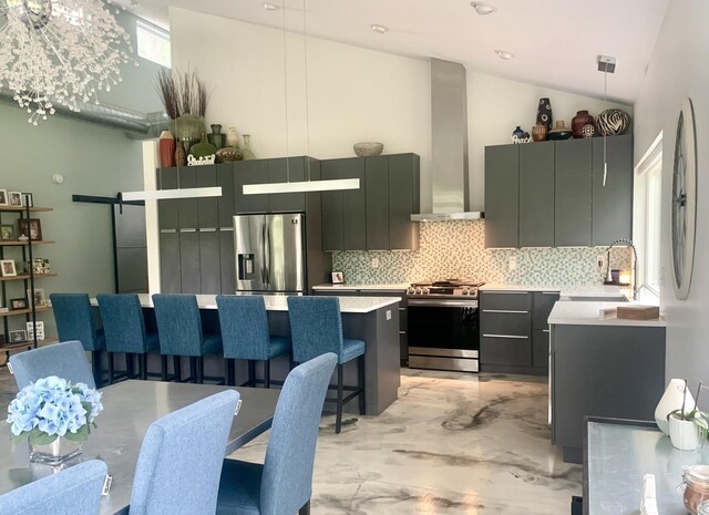 4405 17th Ave NW, Sauk Rapids, MN 56379 - kitchen featuring light countertops, appliances with stainless steel finishes, wall chimney range hood, and a breakfast bar