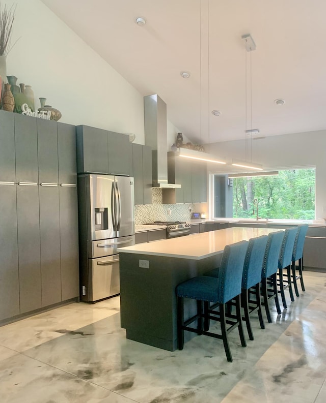 4405 17th Ave NW, Sauk Rapids, MN 56379 - kitchen featuring wall chimney range hood, a kitchen island, gray cabinetry, decorative backsplash, and stainless steel appliances