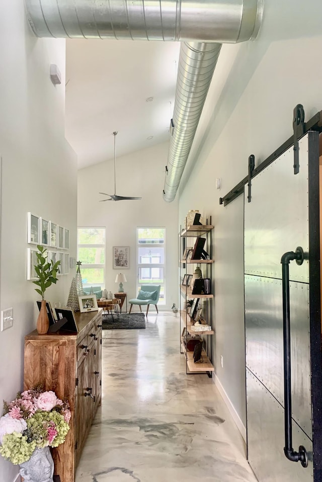 4405 17th Ave NW, Sauk Rapids, MN 56379 - corridor featuring high vaulted ceiling, concrete flooring, baseboards, and a barn door