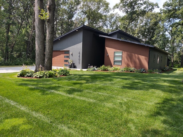4405 17th Ave NW, Sauk Rapids, MN 56379 - view of home's exterior featuring a garage and a lawn