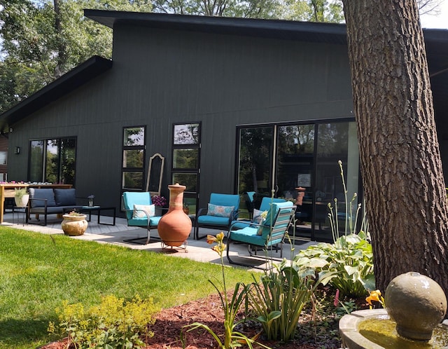 4405 17th Ave NW, Sauk Rapids, MN 56379 - rear view of property featuring a patio area, a lawn, and outdoor lounge area