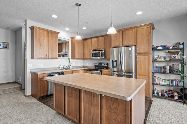 kitchen with stainless steel appliances, a center island, dark carpet, brown cabinetry, and light countertops