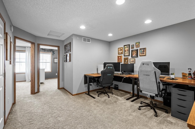 carpeted office with baseboards, a textured ceiling, visible vents, and recessed lighting