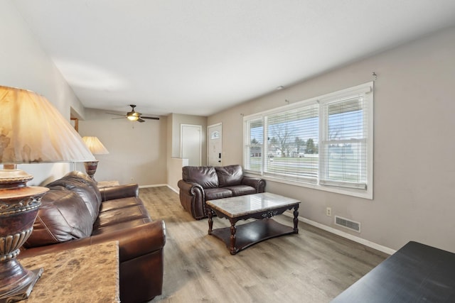 11749 Crooked Lake Blvd NW, Coon Rapids, MN 55433 - living area with visible vents, ceiling fan, wood finished floors, and baseboards