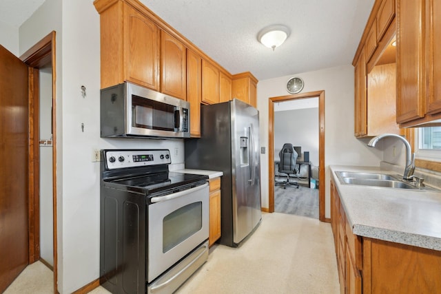 11749 Crooked Lake Blvd NW, Coon Rapids, MN 55433 - kitchen featuring appliances with stainless steel finishes, brown cabinets, light countertops, and a sink