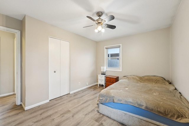 11749 Crooked Lake Blvd NW, Coon Rapids, MN 55433 - bedroom with a closet, a ceiling fan, baseboards, and light wood-type flooring