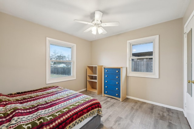 11749 Crooked Lake Blvd NW, Coon Rapids, MN 55433 - bedroom with ceiling fan, light wood-style flooring, and baseboards