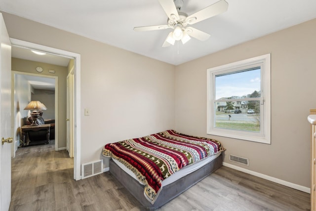 11749 Crooked Lake Blvd NW, Coon Rapids, MN 55433 - bedroom featuring wood finished floors, visible vents, and baseboards