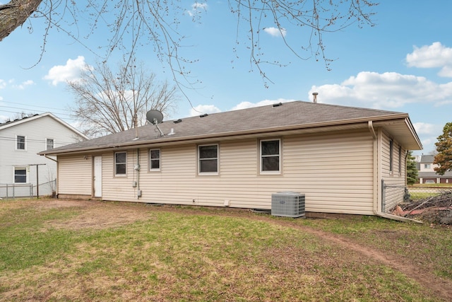 11749 Crooked Lake Blvd NW, Coon Rapids, MN 55433 - rear view of property featuring fence, roof with shingles, a yard, and central air condition unit