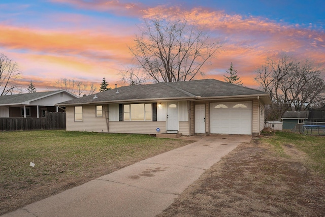 11749 Crooked Lake Blvd NW, Coon Rapids, MN 55433 - view of front of home with driveway, a trampoline, fence, a yard, and a garage