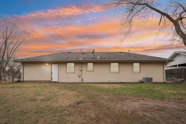 11749 Crooked Lake Blvd NW, Coon Rapids, MN 55433 - back of property at dusk with fence, central AC unit, and a yard