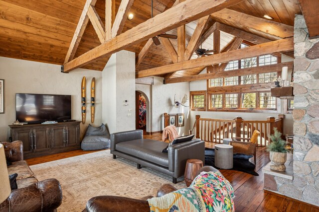 8434 Big Whitefish Narrows, Pine River, MN 56474 - living room featuring arched walkways, wooden ceiling, a ceiling fan, beamed ceiling, and wood-type flooring