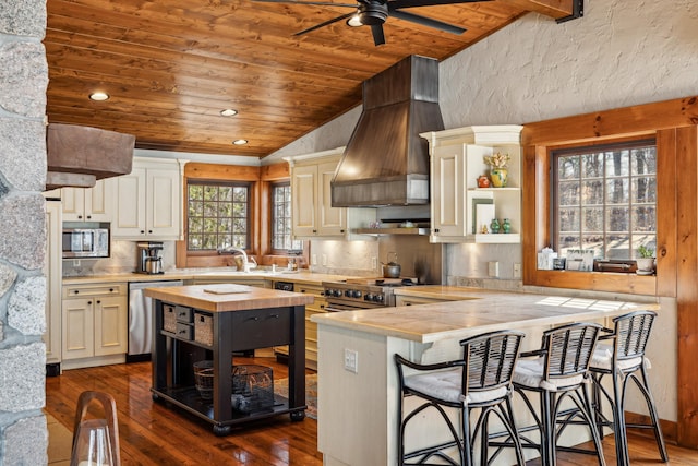8434 Big Whitefish Narrows, Pine River, MN 56474 - kitchen with butcher block countertops, open shelves, vaulted ceiling, stainless steel appliances, and custom range hood