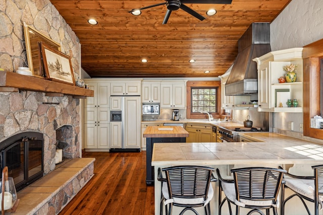 8434 Big Whitefish Narrows, Pine River, MN 56474 - kitchen featuring custom exhaust hood, built in appliances, vaulted ceiling, wooden counters, and wooden ceiling