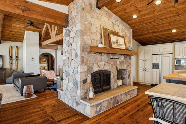 8434 Big Whitefish Narrows, Pine River, MN 56474 - living room featuring dark wood finished floors, arched walkways, a ceiling fan, wooden ceiling, and vaulted ceiling with beams