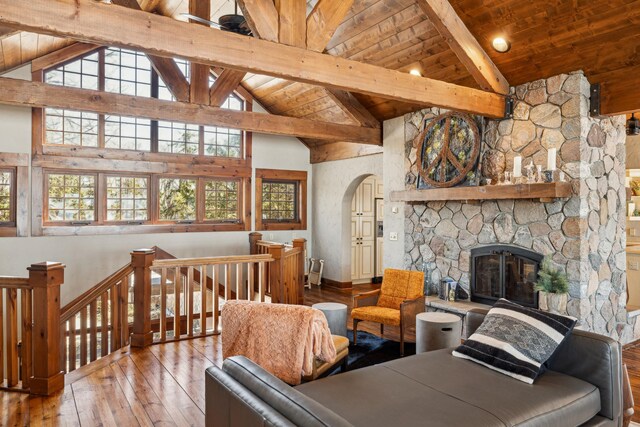 8434 Big Whitefish Narrows, Pine River, MN 56474 - living room with wooden ceiling, arched walkways, a fireplace, beam ceiling, and wood-type flooring