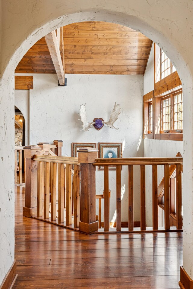 8434 Big Whitefish Narrows, Pine River, MN 56474 - staircase with a textured wall, arched walkways, wood-type flooring, wood ceiling, and vaulted ceiling with beams