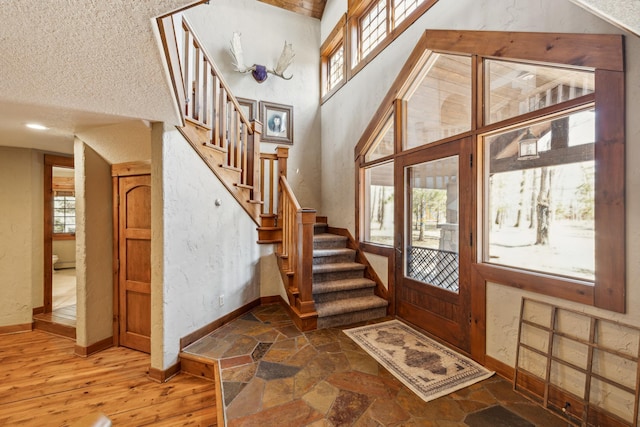 8434 Big Whitefish Narrows, Pine River, MN 56474 - foyer entrance with stone tile flooring, baseboards, stairway, and a high ceiling