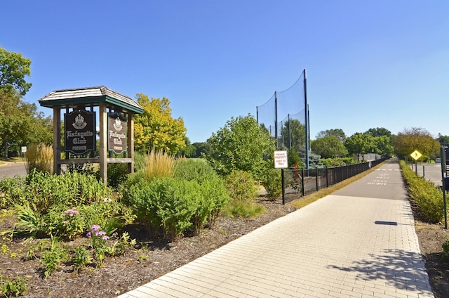 view of home's community featuring fence