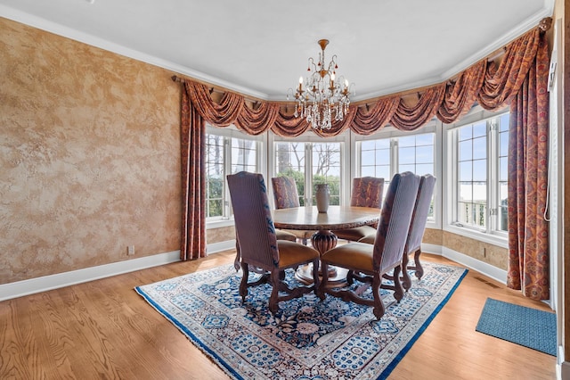 dining area featuring baseboards, plenty of natural light, and light wood-style flooring