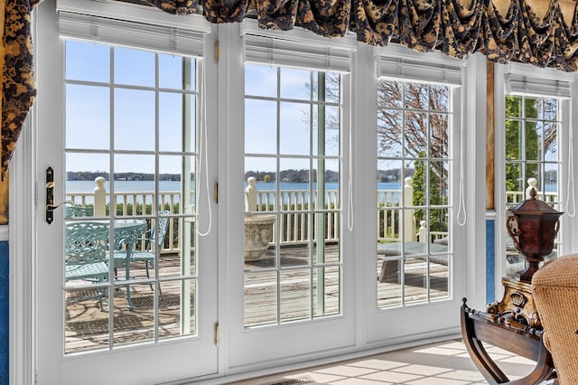 doorway to outside with a water view