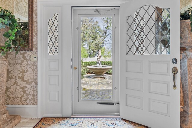 entryway featuring wallpapered walls