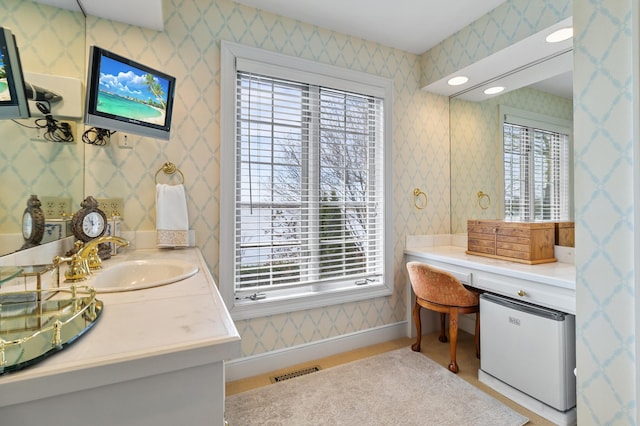 bathroom featuring wallpapered walls, visible vents, and vanity