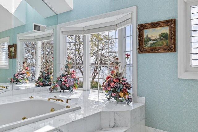 full bathroom featuring a whirlpool tub and visible vents