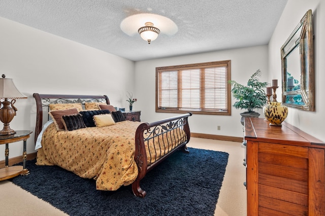 bedroom with carpet floors, a textured ceiling, and baseboards