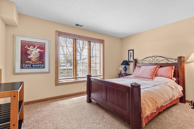 bedroom featuring a textured ceiling, baseboards, visible vents, and carpet