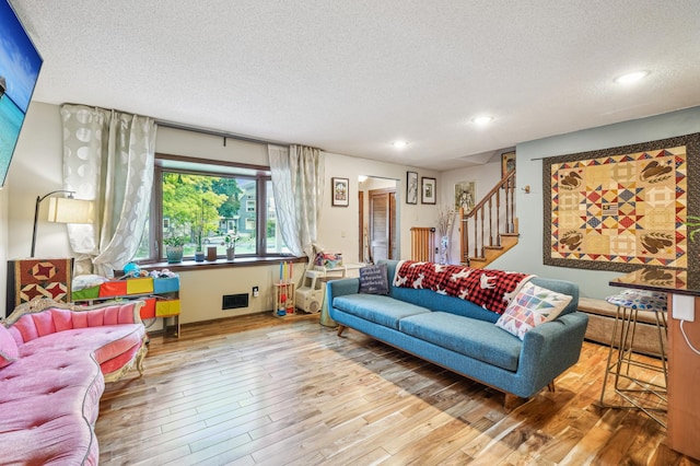 716 6th St NE, Minneapolis, MN 55413 - living area featuring a textured ceiling, stairway, wood finished floors, and recessed lighting