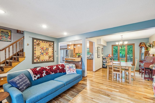 716 6th St NE, Minneapolis, MN 55413 - living room with light wood finished floors, a chandelier, recessed lighting, a textured ceiling, and stairs