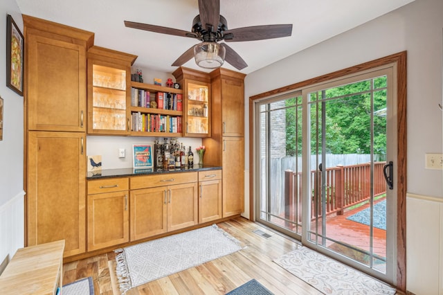 716 6th St NE, Minneapolis, MN 55413 - indoor bar featuring wainscoting, light wood finished floors, and ceiling fan