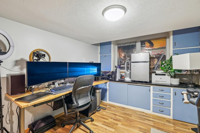 716 6th St NE, Minneapolis, MN 55413 - office area featuring a textured ceiling and light wood-style floors