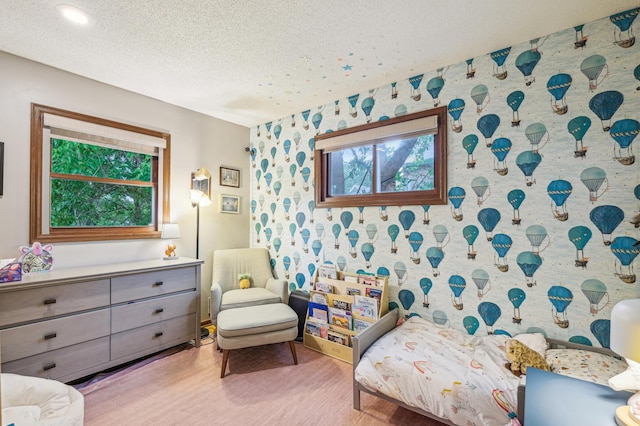 716 6th St NE, Minneapolis, MN 55413 - bedroom featuring wood finished floors, a textured ceiling, and wallpapered walls