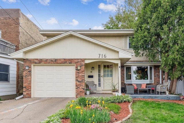 716 6th St NE, Minneapolis, MN 55413 - view of front facade featuring brick siding, driveway, a garage, and a front lawn