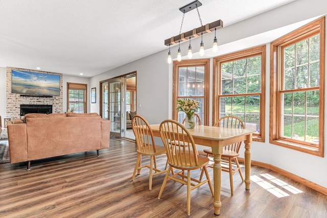 12534 Dover Dr, Apple Valley, MN 55124 - dining space with wood finished floors, a fireplace, recessed lighting, and a textured ceiling