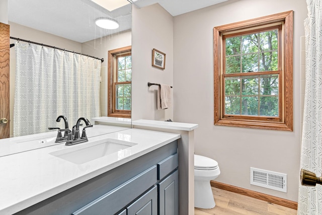12534 Dover Dr, Apple Valley, MN 55124 - bathroom featuring wood finished floors and vanity
