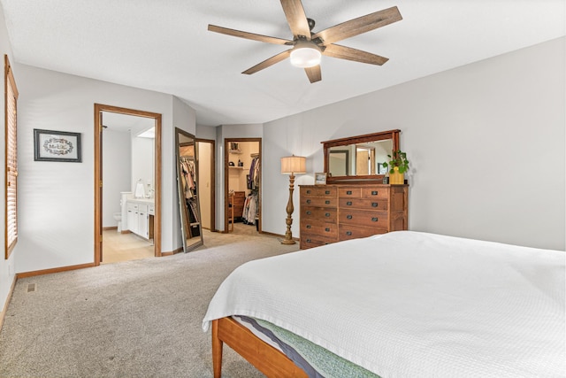 12534 Dover Dr, Apple Valley, MN 55124 - bedroom with light colored carpet, a walk in closet, a ceiling fan, connected bathroom, and a closet