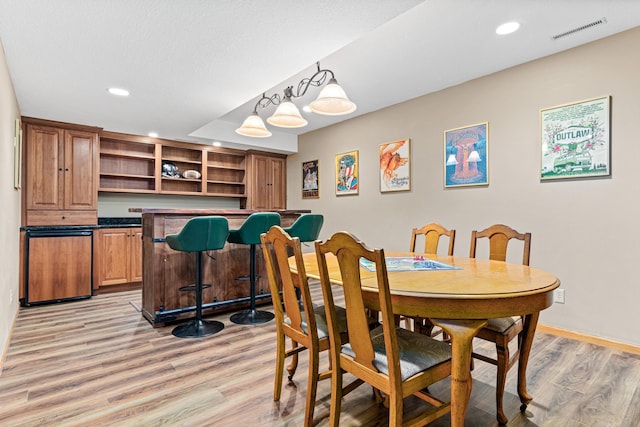 12534 Dover Dr, Apple Valley, MN 55124 - dining area with light wood-style floors, recessed lighting, and a bar