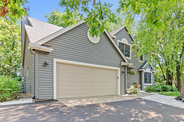 12534 Dover Dr, Apple Valley, MN 55124 - traditional-style home with asphalt driveway, an attached garage, and a shingled roof