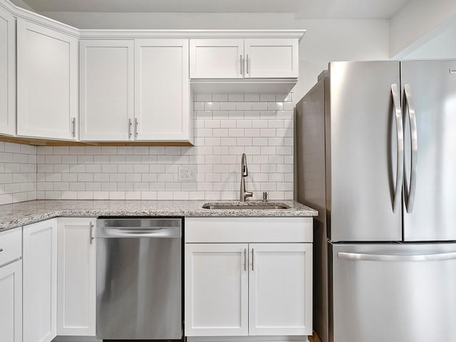 1883 County Road C E, Maplewood, MN 55109 - kitchen with stainless steel appliances, white cabinetry, decorative backsplash, and light stone counters