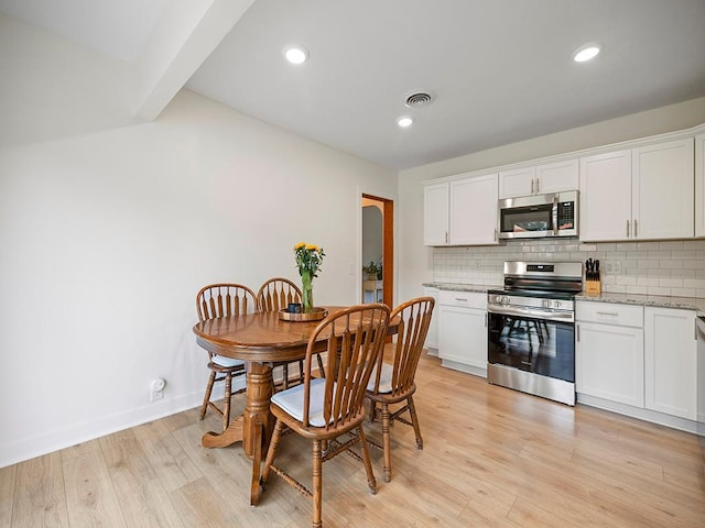 1883 County Road C E, Maplewood, MN 55109 - dining room featuring beam ceiling, light wood finished floors, and recessed lighting
