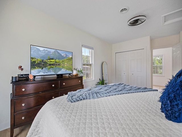 1883 County Road C E, Maplewood, MN 55109 - bedroom with wood finished floors, attic access, and a closet