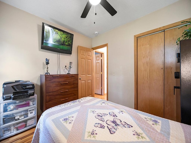 1883 County Road C E, Maplewood, MN 55109 - bedroom with a closet, light wood finished floors, and a ceiling fan