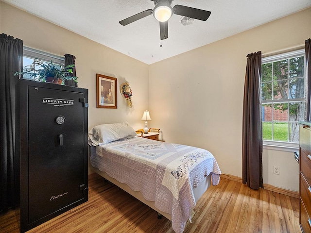 1883 County Road C E, Maplewood, MN 55109 - bedroom featuring wood finished floors and a ceiling fan