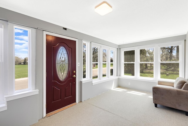view of carpeted foyer entrance